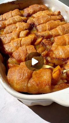 a casserole dish filled with food sitting on top of a white tablecloth