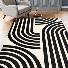 a black and white area rug on the floor in a living room with a chair