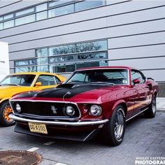 two cars parked next to each other in front of a building