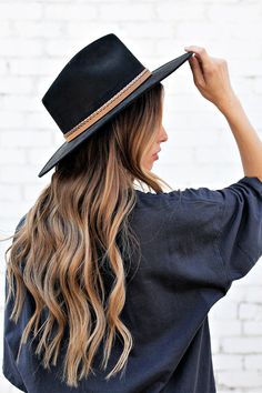 Ok, we're freaking out! The Joshua Hat is our newest favvvvv. It's everything a girl could dream of in a hat. Incredible quality, a pointed rancher crown, super structured, and an elastic inner-band. Black is always in style and you'll be in love. The elegant crown is stiffened and shaped into a clean and ridged design, finished with a braided trim. It's timeless, will last forever, and adds the perfect touch of coolness to any look. -Rancher style hat with some edge -Incredible quality -Brim is Black Flat Crown Fedora For Kentucky Derby, Fall Flat Crown Top Hat, Black Spring Hat With Flat Crown, Black Flat Crown Hat For Spring, Fall Costume Hats With Curved Brim, Black Fedora With Flat Crown For Fall, Wide Brim Black Hat For Ranch, Black Wide Brim Felt Hat For Festival, Black Wide Brim Hat For Ranch