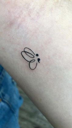 a small tattoo on the arm of a person's left arm, with an insect drawn