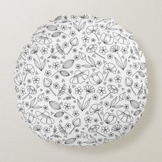 a white plate with black and white floral designs on the front, along with small flowers