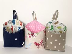 three fabric storage bins sitting on top of a white table next to each other