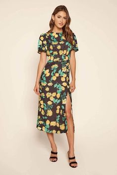 Who doesn't love a simple silhouette with a fun print! The Lima Bloom Floral Midi Dress in Yellow Multi features a round neckline, short sleeves, smocked detailing at the waist, and a front side slit. Pair with simple earrings and black heels for a look that's sure to stand out! Composition & Fit  Round Neckline Short Sleeves Smocked Elastic Waist Midi Length Dress Slit Detail Measurements & Materials  100% Polyester  Model is 5'9 wearing a size X Small Hand Wash Cold Separately, Tumble Midi Skirt Fall, Yellow Midi Dress, Simple Silhouette, Cute Boutiques, Fall Skirts, Woven Dress, Midi Length Dress, Printed Midi Dress, Long Dresses