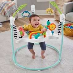 a baby sitting in a bounce n'play gym