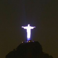 the christ statue is lit up at night