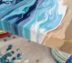 a close up of a table with blue and white paint on it's surface