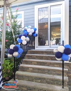 blue and white balloons are on the steps