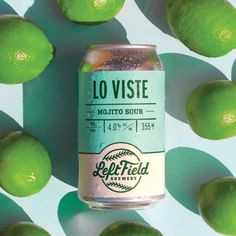 a can of soda surrounded by limes on a blue and green background with the words lo vistae mojito sour