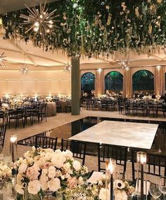 an indoor event with tables, chairs and chandeliers