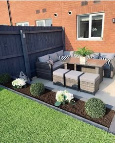 an outdoor patio area with furniture and landscaping