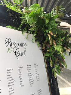 wedding seating sign with greenery on it for guests to sit down at the ceremony