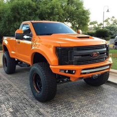 an orange truck is parked on the street