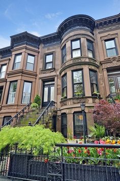 an apartment building with many windows and plants