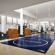 an indoor gym with exercise mats and equipment