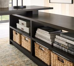 a book shelf with baskets and books on it