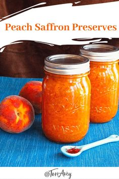 three jars filled with peach jam sitting on top of a blue table