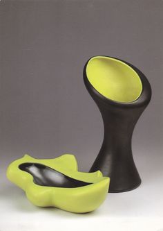 two black and yellow vases sitting next to each other