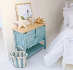 a bedroom with white walls and blue furniture