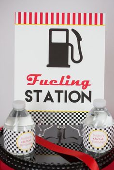 a black tray topped with two soda bottles and a sign that says fueling station