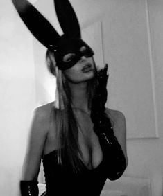 a woman wearing bunny ears and latex gloves