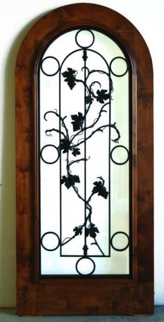 a wooden and glass door with vines on it