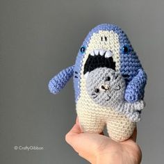 a crocheted toothbrush holder in the shape of a shark with its mouth open