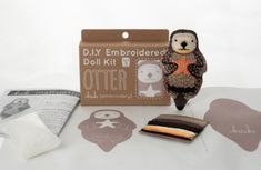 an owl doll sitting on top of a table next to some other items and papers