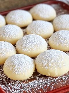 powdered sugar cookies on a red tray