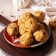 a red plate filled with oatmeal cookies on top of a wooden table