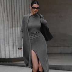 This Women’s Knitted Long Sleeve Sexy Slit Bodycon Dress is crafted from a blend of 95% polyester and 5% spandex, providing a soft and comfortable fabric, perfect for the upcoming autumn and winter seasons. The minimalist solid color design, paired with a stylish slit, exudes elegance and sensuality. The bodycon fit highlights the wearer’s curves, enhancing a slim waistline and graceful leg silhouette. The faux two-piece cardigan-style design adds a modern and trendy touch, making this dress a s Girls Long Dresses, Long Knitted Dress, Winter Mode, فستان سهرة, Body Con Dress, Slim Fit Dresses, Ann Demeulemeester, Looks Chic, 가을 패션