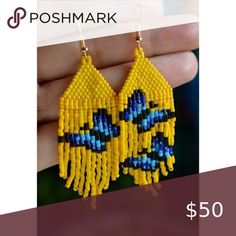 a pair of yellow and blue beaded earrings with the words poshmark on it