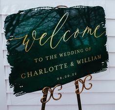 a welcome sign for the wedding of charlotte and william in front of a white house