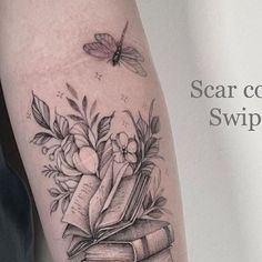 a black and white photo of a tattoo with books, flowers and butterflies on it