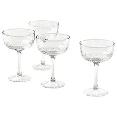 four empty wine glasses sitting next to each other