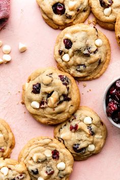 cranberry white chocolate chip cookies on a pink surface