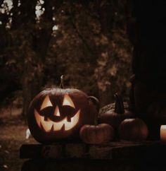 a carved pumpkin sitting on top of a wooden table