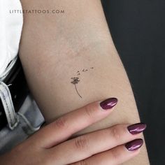 a woman's arm with a small dandelion tattoo on her left wrist