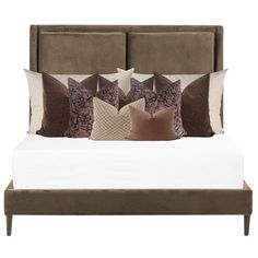 a bed with several pillows on it and a headboard in the backround