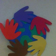 colorful paper cutouts of hands on a white wall