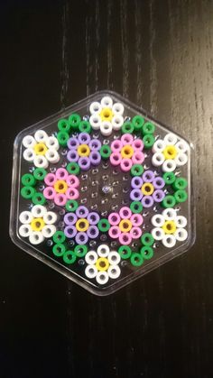 a hexagonal object made out of plastic beads