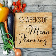 a wooden sign that says,'52 weeks of menu planning'surrounded by vegetables