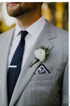 a man in a suit with a boutonniere on his lapel