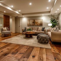 a living room filled with furniture and a large rug on top of a hard wood floor