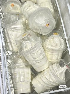 plastic cups and lids are stacked in a bin for storage or to be filled with liquid