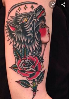 a woman's arm with a wolf and rose tattoo design on the left forearm