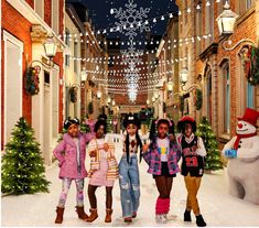 three girls are standing in front of a christmas sign