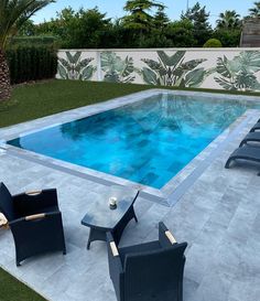 an empty swimming pool surrounded by lawn chairs