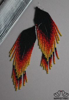 These fire red beaded earrings are made of high-quality Czech beads and strong synthetic thread. They are elegant, fashionable, and highly versatile, suitable for everyday wear. Features: Sterling silver components Color: black, red, yellow. This item is currently in stock. You must be completely satisfied. If you find merchandise unsatisfactory for any reason, return it within 10 days and your money will be refunded without questions. More beaded earrings http://etsy.me/2ycItdb Gerdan necklaces Red And Black Beaded Drop Earrings, Red Beaded Fringe Drop Earrings, Red Chandelier Earrings With Colorful Beads, Traditional Red Beaded Chandelier Earrings, Red Round Bead Earrings For Festivals, Red And Black Beaded Festival Earrings, Red And Black Beaded Earrings For Festival, Red Drop Earrings With Black Beads, Traditional Red Earrings With Black Beads