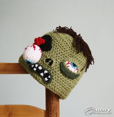 a crocheted zombie hat on top of a wooden chair